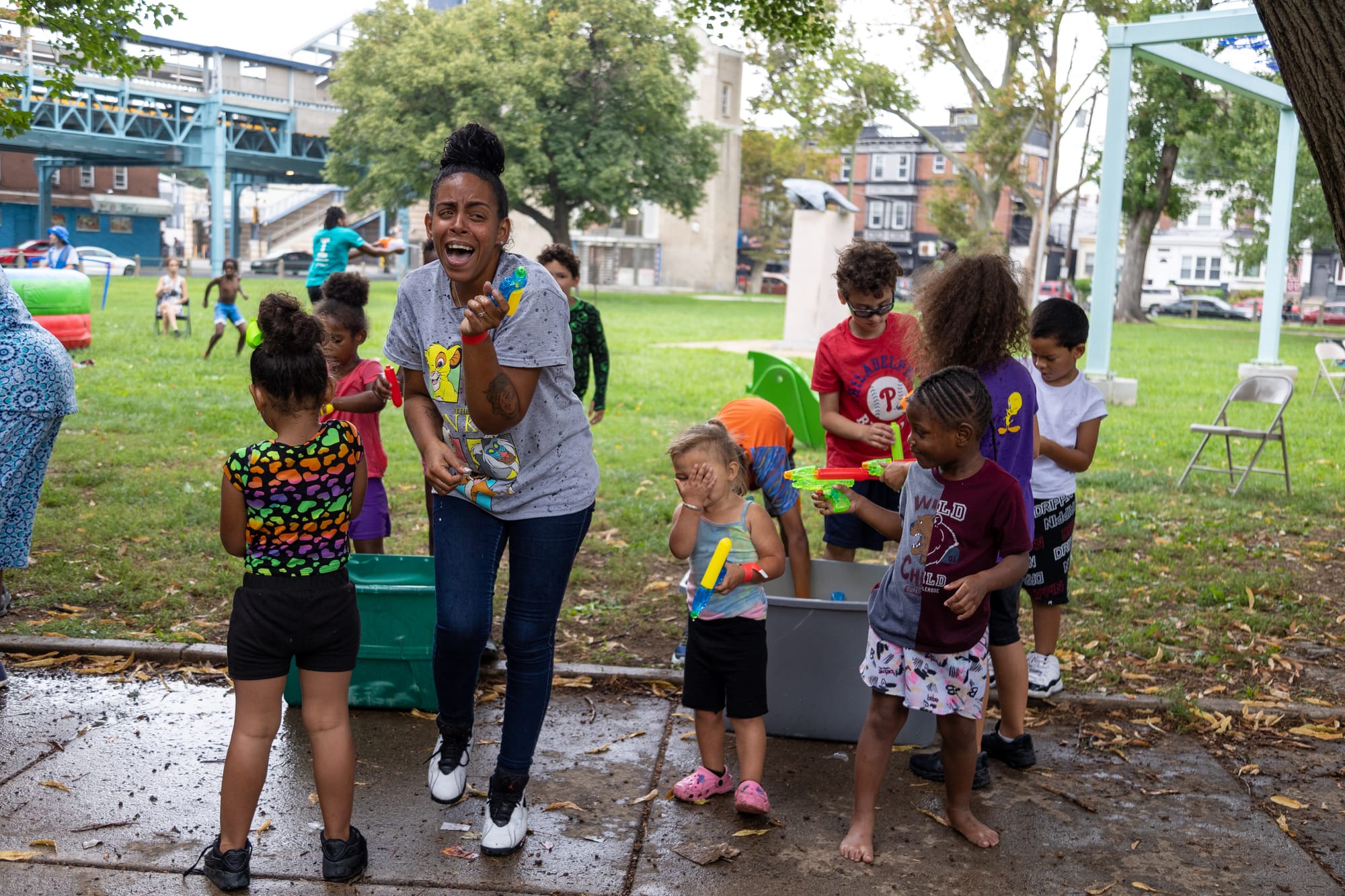 Photos of Kensington: Community members participate in the second annual "Community Water Gun Fight" in Harrowgate Park.