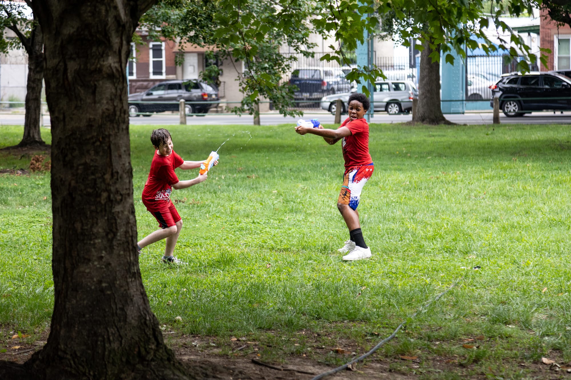 Photos of Kensington: Community members participate in the second annual "Community Water Gun Fight" in Harrowgate Park.