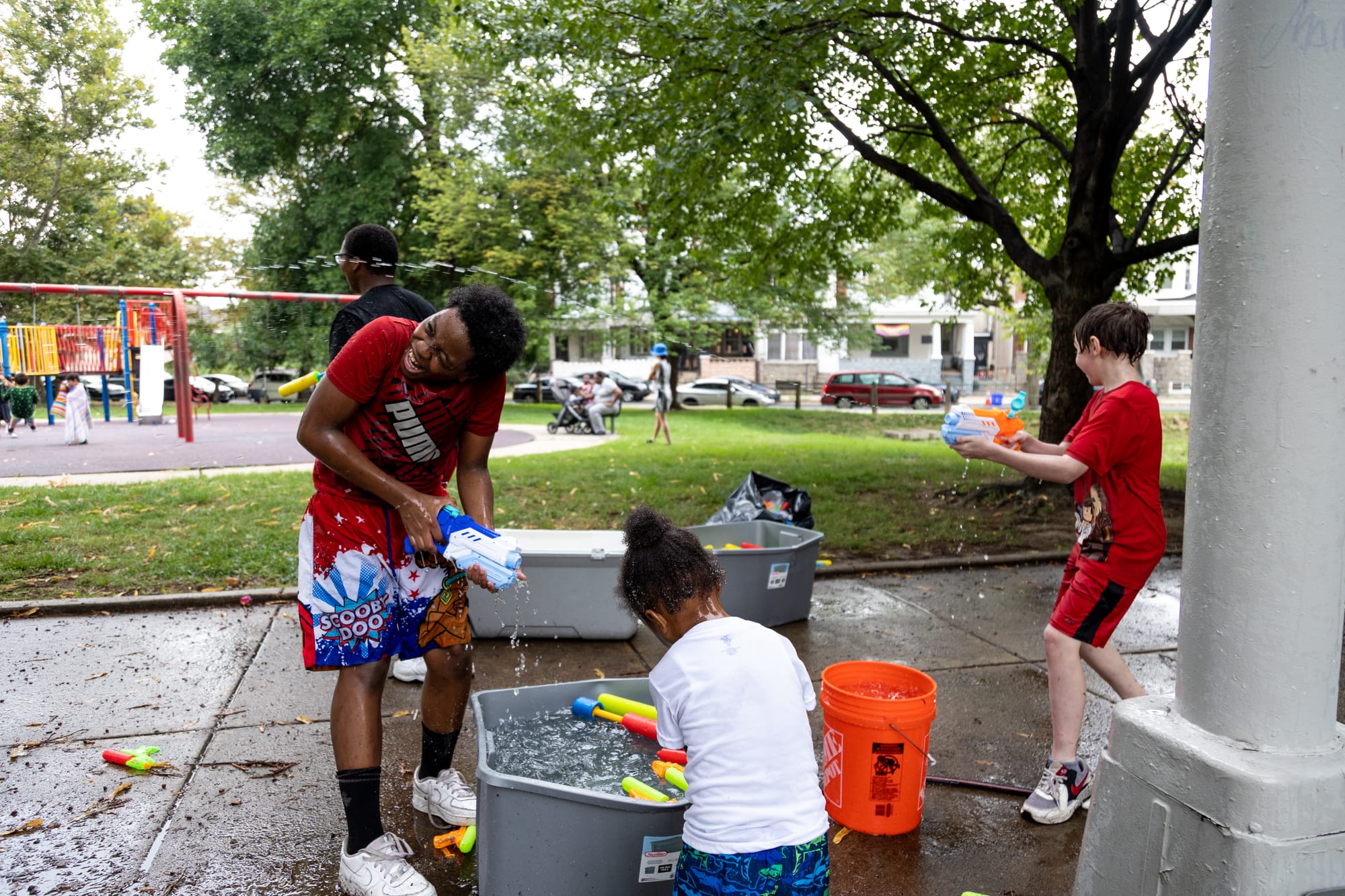 Photos of Kensington: Community members participate in the second annual "Community Water Gun Fight" in Harrowgate Park.