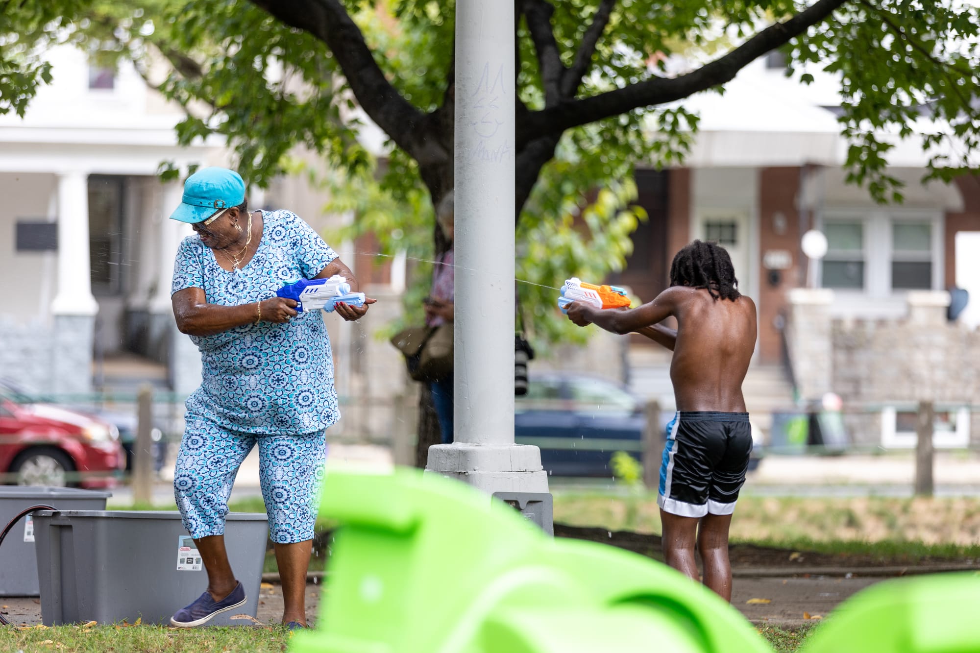 Photos of Kensington: Community members participate in the second annual "Community Water Gun Fight" in Harrowgate Park.