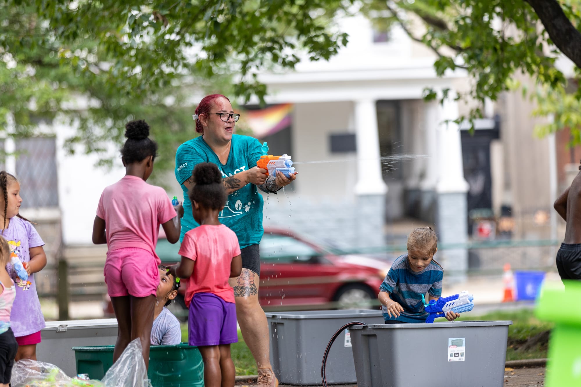 Photos of Kensington: Community members participate in the second annual "Community Water Gun Fight" in Harrowgate Park.