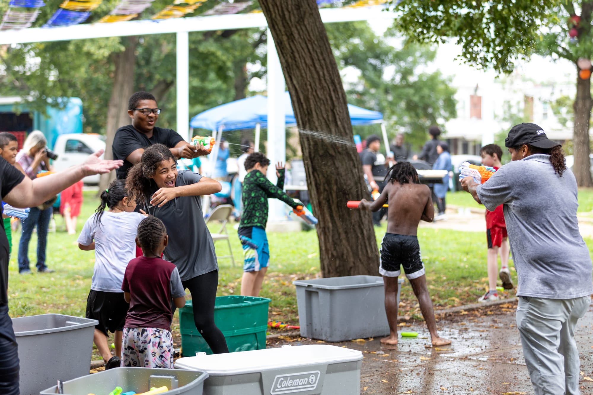 Photos of Kensington: Community members participate in the second annual "Community Water Gun Fight" in Harrowgate Park.